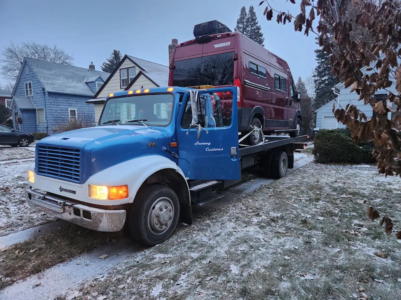 Winnebago camper van towed on an icy winter street